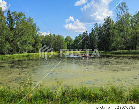 Boats float on an ancient pond. 128970883