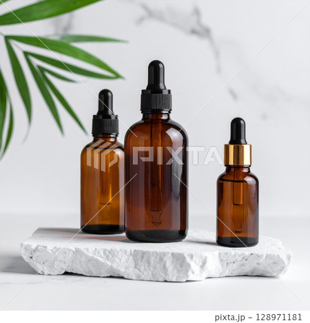 Amber Glass Cosmetic Bottles on Stone Slab with Green Leaf Minimalist Style 128971181