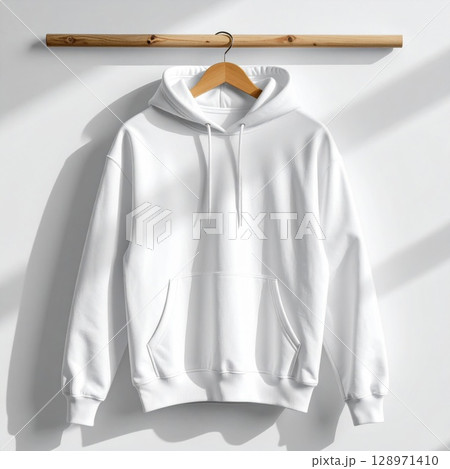 White Hoodie on Wooden Hanger Against White Wall in Studio Shot White Hoodie on Wooden Hanger Against White Wall in Studio Shot 128971410
