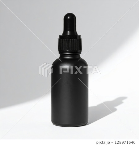 Black Dropper Bottle with Essential Oil on White Seamless Background 128971640