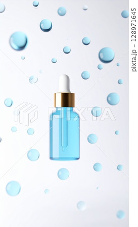 Blue Serum in Glass Bottle with Dropper Surrounded by Water Droplets on White Blue Serum in Glass Bottle with Dropper Surrounded by Water Droplets on White 128971645