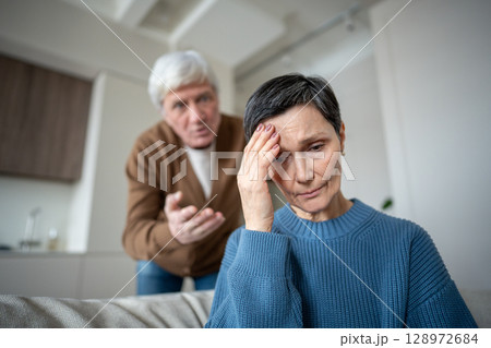 Elderly couple in conflict, man blaming wife remains frail and fearful, narcissistic husband 128972684