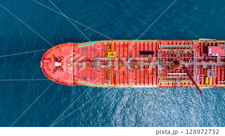 Aerial view oil tanker ship vessel loading and unloading in oil terminal station refinery, Global business import export logistic transport sea freight cargo tanker ship crude oil tanker ship at port. Aerial view oil tanker ship vessel loading and unloading in oil terminal station refinery, Global business import export logistic transport sea freight cargo tanker ship crude oil tanker ship at port. 128972732