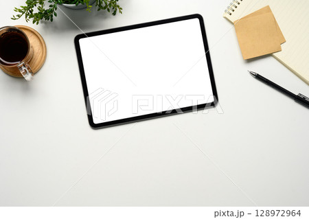 Flat lay of digital tablet with blank screen and office supplies 128972964