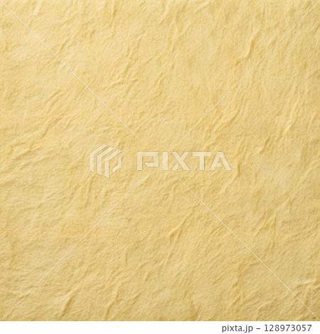 The image displays a wrinkled light yellow paper texture, resembling parchment or handmade paper, with soft shadows enhancing the uneven The image displays a wrinkled light yellow paper texture, resembling parchment or handmade paper, with soft shadows enhancing the uneven 128973057