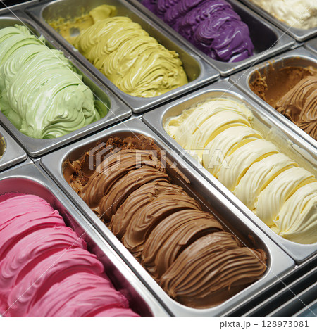 Assorted gelato flavors in metal trays at ice cream shop 128973081