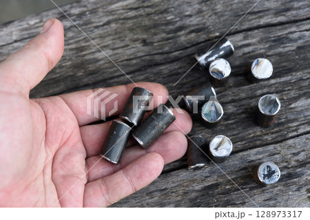 Metal bars in your hand. Cut metal fittings. Metal bars in your hand. Cut metal fittings. 128973317