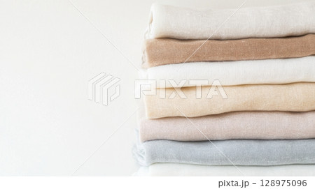 Light clothes stacked in minimalist style, suitable as background 128975096