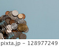 Spilled Thai Baht Coins on Blue, Finance and Saving 128977249