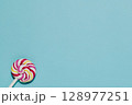 Swirl Lollipop on Blue, Sweet Treat and Childhood Fun 128977251