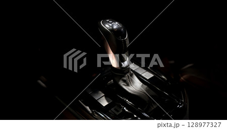 EV Car gear. Close up of modern automatic car gear shifters in luxury vehicle interiors. Feature sleek ergonomic designs and advanced car transmission controls for premium driving experience. EV gear 128977327