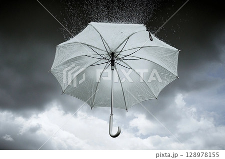 Umbrella suspended in the sky with rain falling, surrounded by vibrant clouds and a dramatic atmosphere 128978155