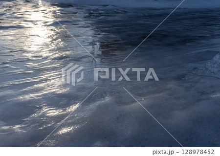 Glossy Frozen Surface Reflecting Winter Light Under a Clear Sky Glossy Frozen Surface Reflecting Winter Light Under a Clear Sky 128978452