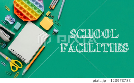 A green background with school supplies and the words school facilities 128978788