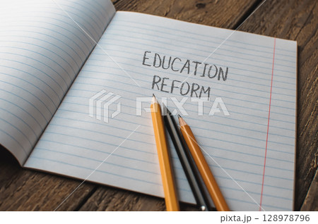 A notebook with pencils on it and the word education reform written on it A notebook with pencils on it and the word education reform written on it 128978796