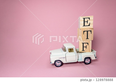 White truck is carrying wooden blocks on top of it 128978888