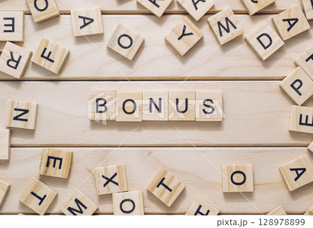 Bunch of wooden letters spell out the word bonus Bunch of wooden letters spell out the word bonus 128978899