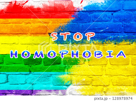 A colorful wall with the words Stop Homophobia written on it 128978974