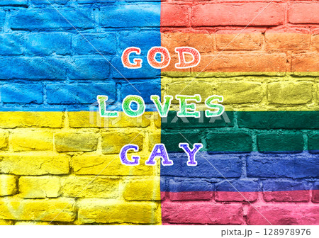 A colorful brick wall with the words God loves gay written on it 128978976
