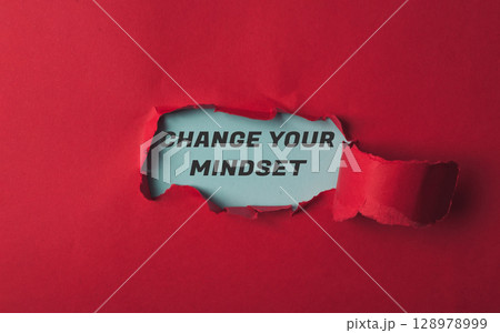 A red background with a torn piece of paper with the words Change Your Mindset A red background with a torn piece of paper with the words Change Your Mindset 128978999
