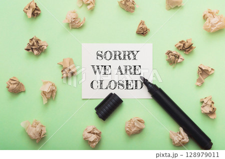 Sorry we are closed sign on a green background with a marker 128979011