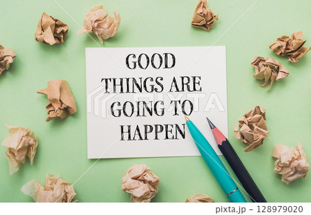 Piece of paper with the words "Good things are going to happen" written on it Piece of paper with the words "Good things are going to happen" written on it 128979020