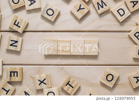 A wooden board with a crossword puzzle on it 128979055
