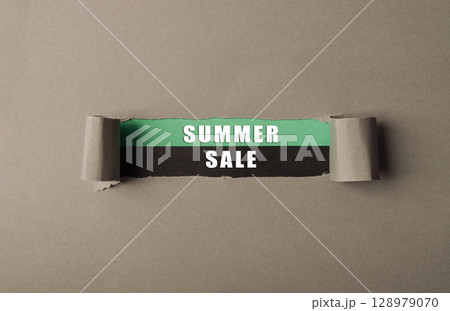 A torn piece of paper with the words Summer Sale written on it A torn piece of paper with the words Summer Sale written on it 128979070
