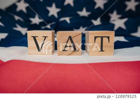 Wooden block with the letters VAT on it Wooden block with the letters VAT on it 128979125