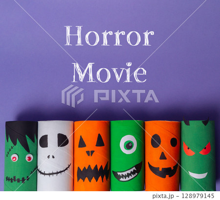 Collection of Halloween themed paper tubes with faces on them 128979145