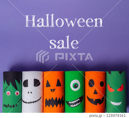 Bunch of Halloween themed paper tubes with faces on them 128979161
