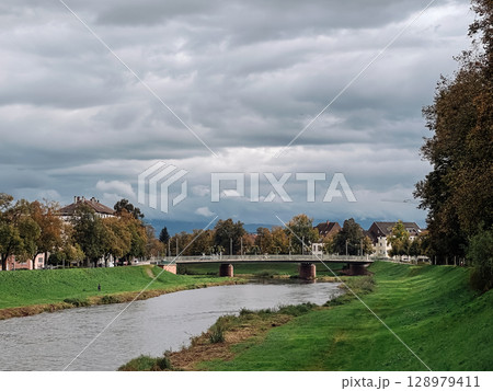 Bridge spans a river in a town Bridge spans a river in a town 128979411
