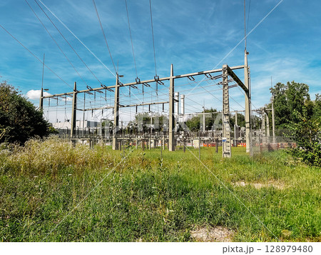Power station with a lot of wires and poles Power station with a lot of wires and poles 128979480
