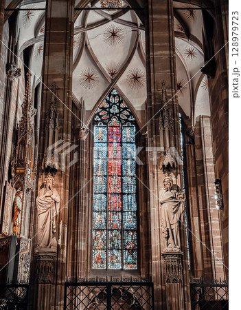 The stained glass window in the church is very colorful and has a lot of detail 128979723