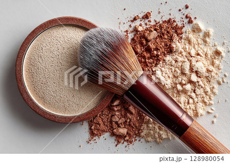 Perfect for luxury beauty brands or makeup artist professionals. Palette with loose powder. Flat lay of makeup brush placed next to a color palette on white background. 128980054