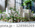 Model of a city with a hill and trees. 128980269