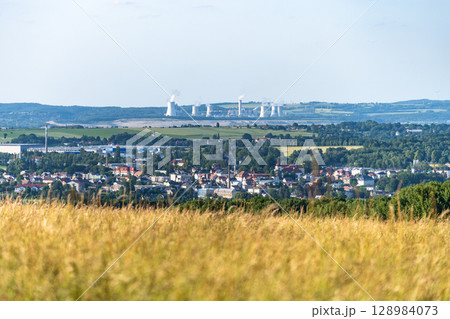 Hradek nad Nisou showcases a picturesque backdrop with the Turow Coal Mine visible in the distance. The blend of urban and industrial elements highlights the region's character. Hradek nad Nisou showcases a picturesque backdrop with the Turow Coal Mine visible in the distance. The blend of urban and industrial elements highlights the region's character. 128984073