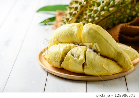 Durian fruit. Ripe monthong durian on sack and white wood background, king of fruit from Thailand on summer 128986373