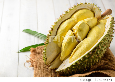Durian fruit. Ripe monthong durian on sack and white wood background, king of fruit from Thailand on summer 128986374