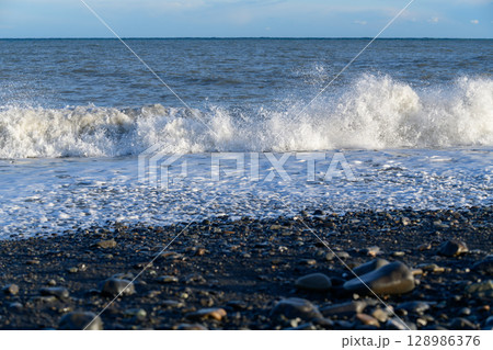 Big wave and black stone beach at Miho no Matsubara, UNESCO World Heritage Site 128986376