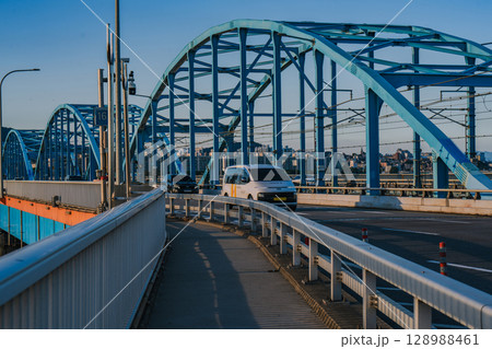 Cars Running on the Dongjak Bridge on the Han River in Seoul, Korea, filmed in the late afternoon of summer Cars Running on the Dongjak Bridge on the Han River in Seoul, Korea, filmed in the late afternoon of summer 128988461