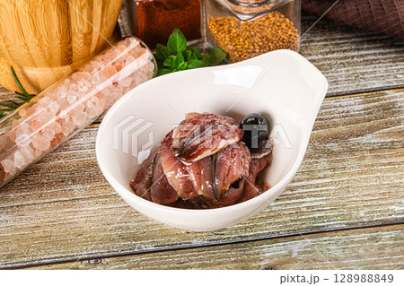 Canned anchovy with oil in the bowl 128988849