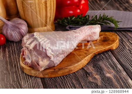 Raw turkey drumstick leg over board Raw turkey drumstick leg over board 128988944