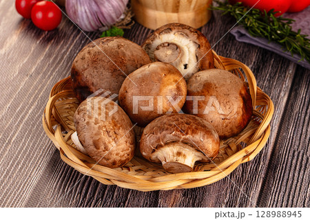 Raw brown champignon heap for cooking 128988945