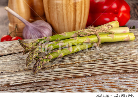 Raw green asparagus over board Raw green asparagus over board 128988946