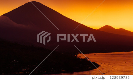 Coastline with Agung volcano with sunset or sunrise in Bali. 128989783