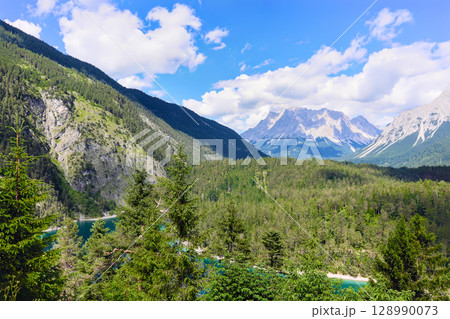 Alpine landscape with forest and mountain lake 128990073