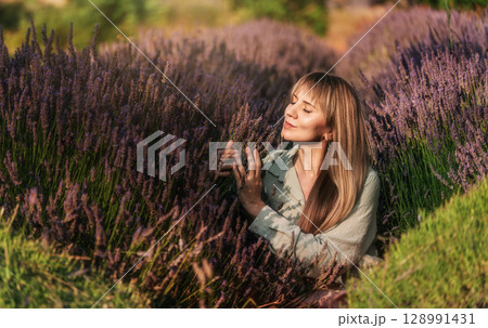 Woman Enjoying Serene Moment in Lavender Field 128991431