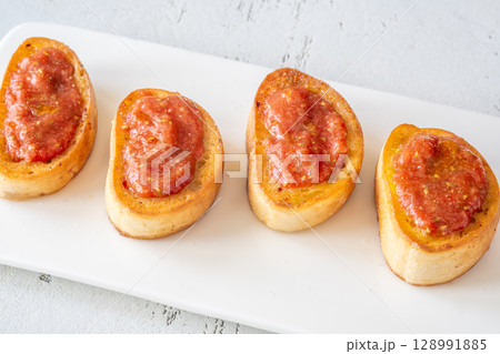 Traditional Pan con Tomate Sandwiches Served on White Plate with Rustic Style 128991885