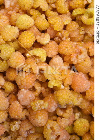 Yellow raspberries in close-up. Juicy sweet yellow berries. Yellow raspberries in close-up. Juicy sweet yellow berries. 128991977
